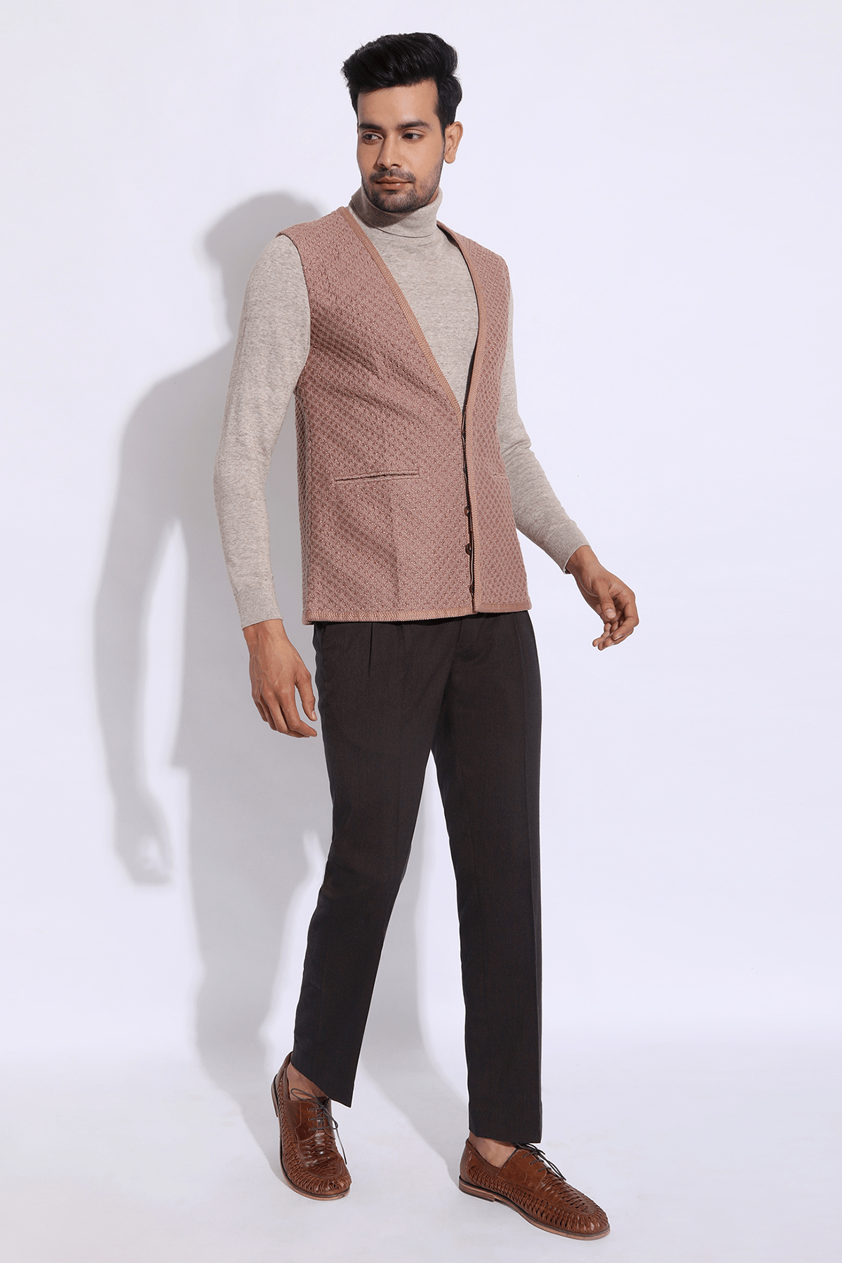 Beige textured long waist coat jacket with beige polo neck and brown trousers - Kunal Anil Tanna