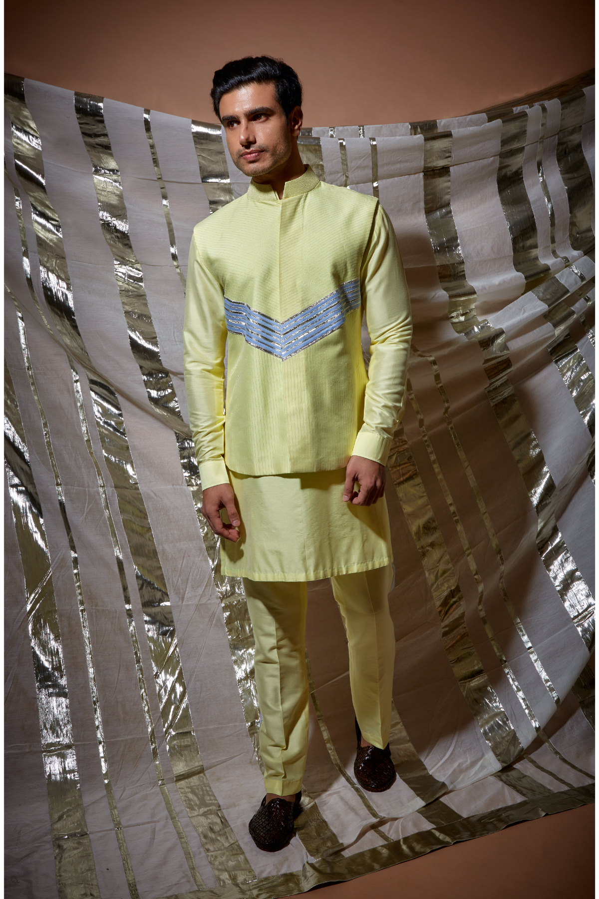 Yellow zari textured bandi jacket with blue detail paired with yellow kurta and pyjama pants - Kunal Anil Tanna